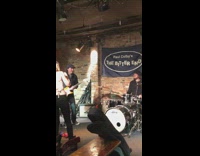 Live band named Paul Colby's The Bitter End plays concert at cafe
