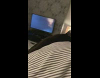 Black cat plays fetch hair tie bedroom