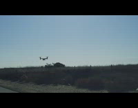 Man in car see tilt rotor helicopter