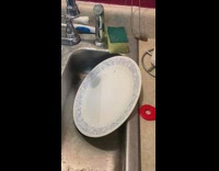 Plate touched and wobbles with sound on the sink
