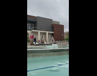 Woman white onesie walk on shallow pool