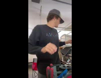 Guy uses massage gun to test elbow reflex 