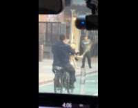 Man rides bike with skeleton on basket