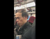 Man on subway closes his eyes and raises his eyebrows up and down