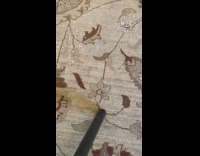 Vacuum cleans and sucks small white balls on the floor