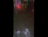 Man leaves flooded porche behind on street