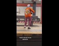 Man with blue mask and orange flower sweater