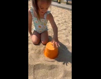 Young girl try to make sandcastle fails