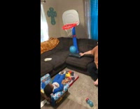 3 year old shoots basketball into toy hoop 