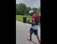 Guy at park with snake wrapped around arm 