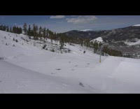 Skier does double back flip, lands on back of skis, and falls down slope