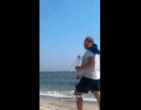 Collab WINY - Man casually walks on beach with birds