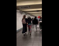 Collab Subway Creatures - Woman walks with alien mask on back