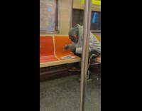 Man grey jacket brush teeth inside train