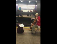 Guy plays cello violin other side subway 