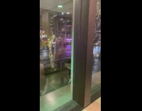 Lady walks with box of pizza on head 