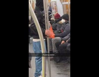 Guy on subway train caresses pole weirdly