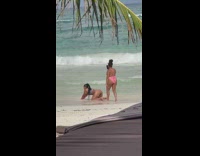 Woman in a thin bikini lie down on the beach shore Part 2