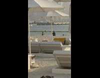 Girl bikini dance lure cameraman beach umbrella