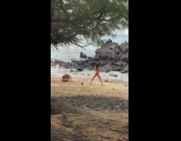 Woman bikini yoga exercise with man lifts rock