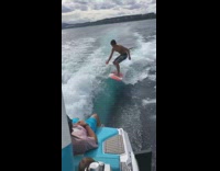 Guy juggles while surfing 