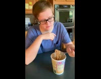 Woman in blue shirt tries smores ramen