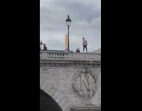 Guy long sleeves stand over ledge bridge
