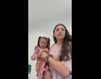 Woman tests her daughter on how long she will hold on 