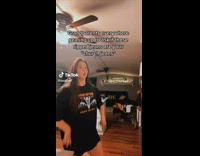 Girl black shirt dancing in room 