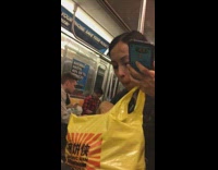 Woman picks up different pretzels with hands and eats out of yellow bag on subway train