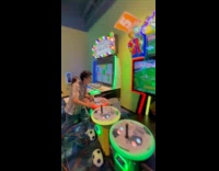 Teen demonstrating how to play soccer arcade game