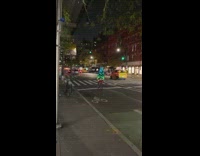 Guy biking around on bike with multiple LED color outfit