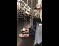 a man on a subway surrounded by his things on subway