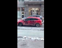 Mans car with vandalism on side 