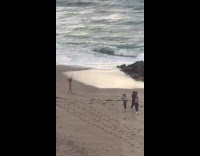 Woman beach dress walks hat flies off