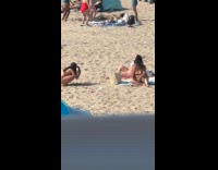 Woman in bikini at beach blanket poses