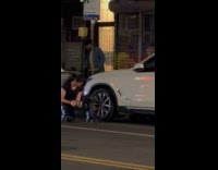 Woman with guitar filming music video on street