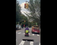 Elderly man rides mobility scooter through red light 