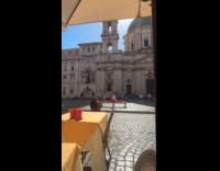 Woman split on bench near historic building