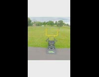 Guy black rollerblades yellow football goal post