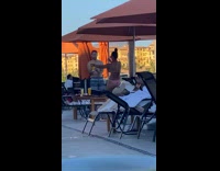 Woman leg split upward hold drink umbrella