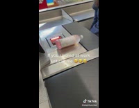 Lady Rolls Bottle of Alcohol over Scanner