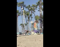 Girl balances backwards off pole 