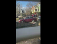 Red shirt guy lifted by friends car