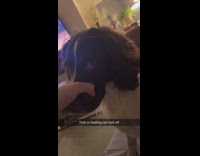 Woman holds dogs snout to prevent barking