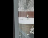 Woman white jacket snow tripod ring light