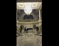 Guy plays piano in mansion 