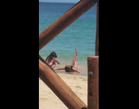 Girl lay sand raise leg wood railings