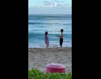 Woman violet beach dress poses for photo