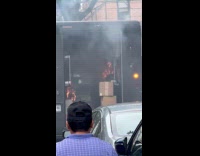 Truck parked with burning objects inside container